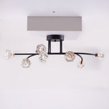 A black and gold ceiling-mounted light fixture with multiple curved arms and crystal-like bulbs.