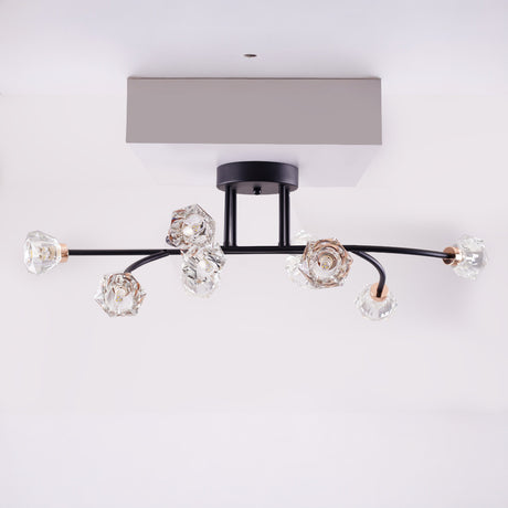 A black and gold ceiling-mounted light fixture with multiple curved arms and crystal-like bulbs.