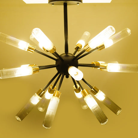 A black chandelier with long, exposed tube bulbs arranged in a starburst pattern, illuminated and casting a warm yellow glow.