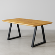 Wooden table with black metal legs on a plain background