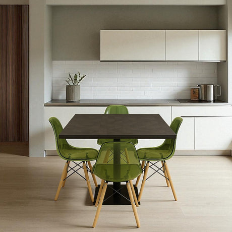 Dining area with a table and green chairs in a modern kitchen.