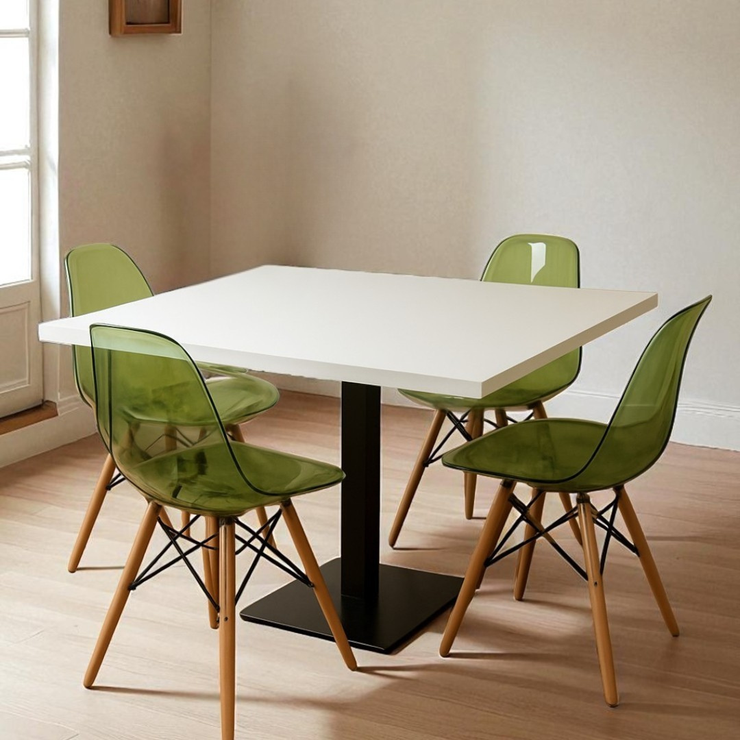 Dining table with four green chairs in a room with light-colored walls and wooden floor.