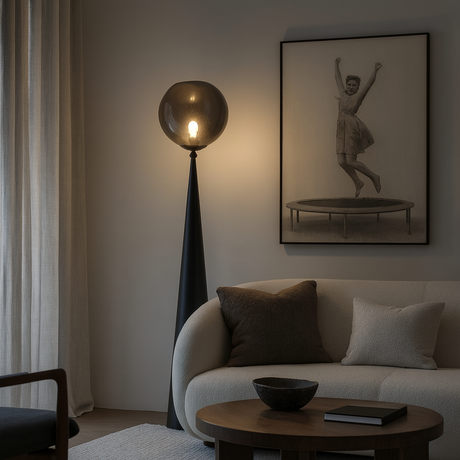 Modern living room with a lamp, sofa, and wall art.