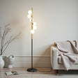 Modern floor lamp with spherical bulbs in a living room setting.
