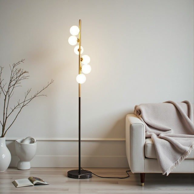 Modern floor lamp with spherical bulbs in a living room setting.