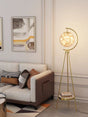 Modern living room with a stylish floor lamp, sofa, and abstract art.