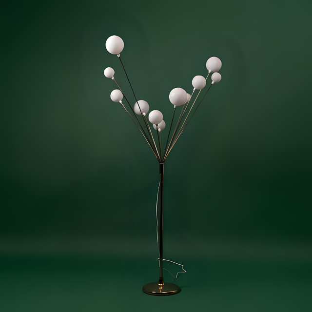A modern artistic floor lamp with multiple spherical white bulbs branching out from a central metallic stand, set against a green background.