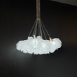 Glass chandelier with a cloud-like design on a black background