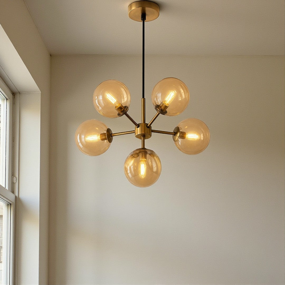 Gold chandelier with multiple bulbs hanging from the ceiling.
