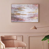 Modern living room with a pink chair, ottoman, and abstract painting on a beige wall.