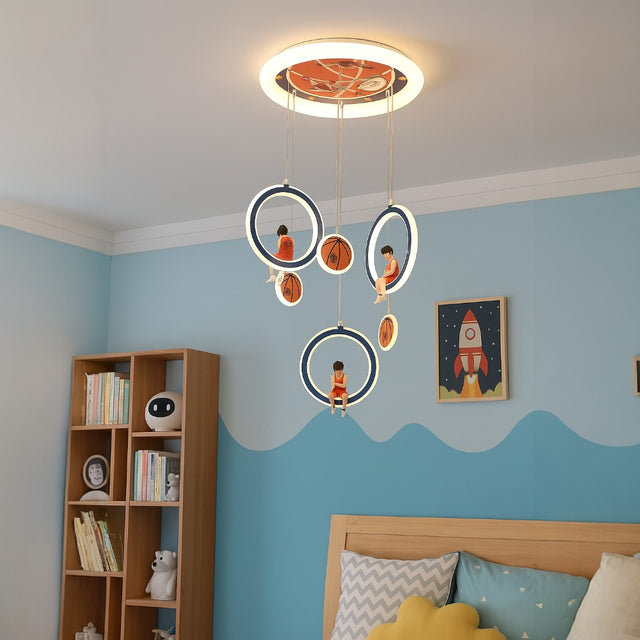 Children's room with blue walls, a bookshelf, and decorative ceiling light fixture.