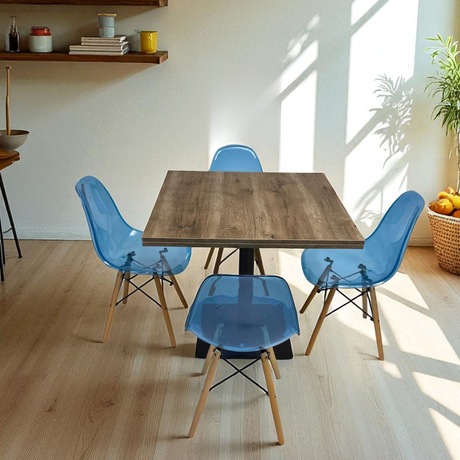 Dining area with a wooden table and blue chairs in a bright room.