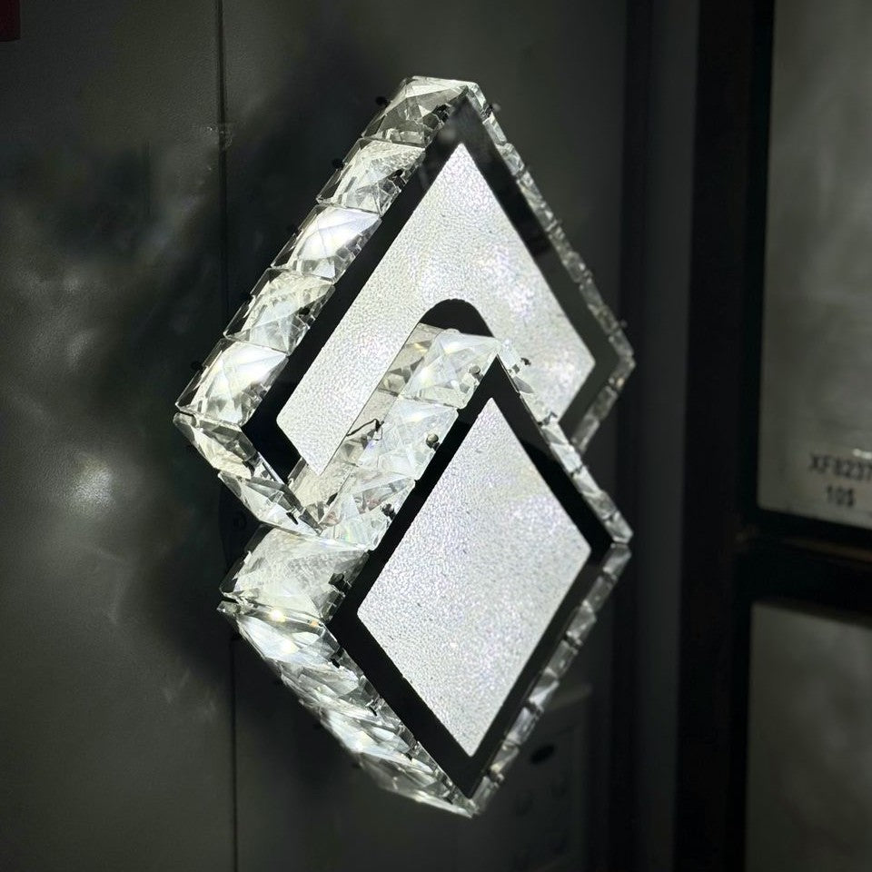 diamond-shaped LED wall light with a frosted crystal-like texture, mounted in an dark wall
