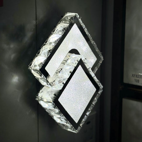 diamond-shaped LED wall light with a frosted crystal-like texture, mounted in an dark wall