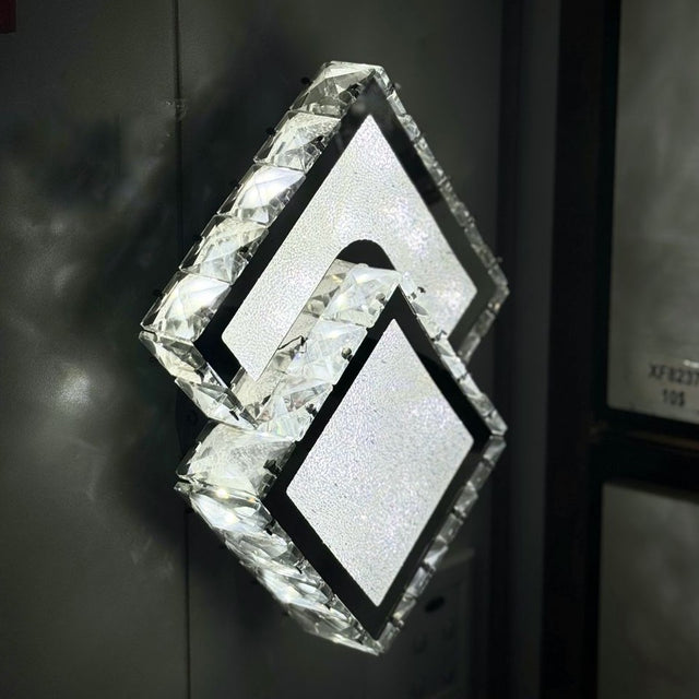 diamond-shaped LED wall light with a frosted crystal-like texture, mounted in an dark wall