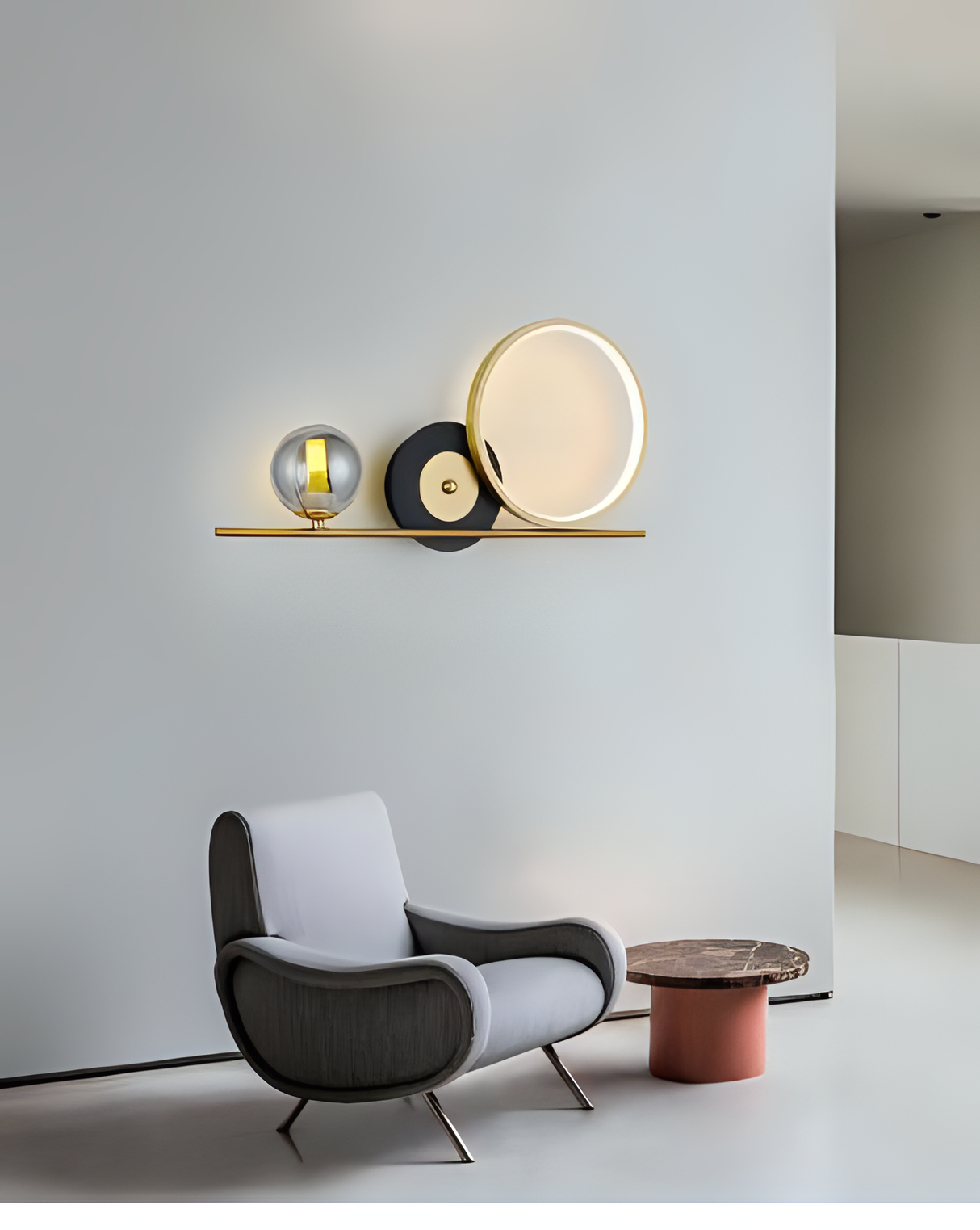 A stylish wall-mounted fixture with a gold bar and geometric elements, placed above a designer chair, complementing the minimalist decor.