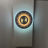 White round wall lamp featuring a small flower motif, mounted on a white wall.