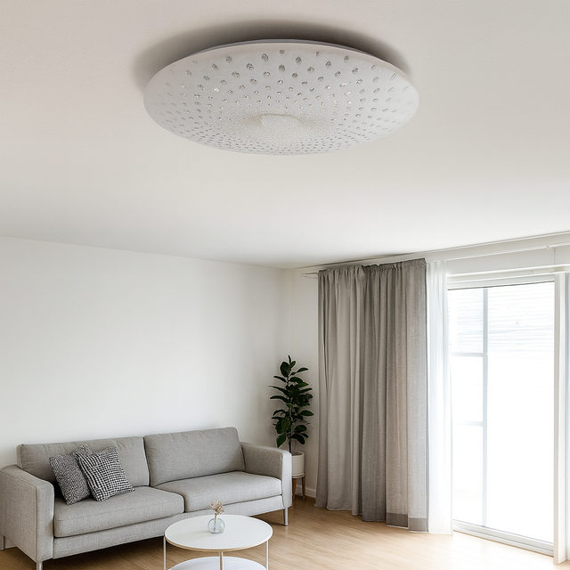 Ceiling light fixture in a modern living room with a gray sofa and large window.