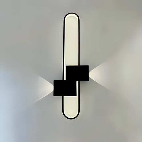 A contemporary black and white oval-shaped wall light with a linear LED strip creating a soft glow
