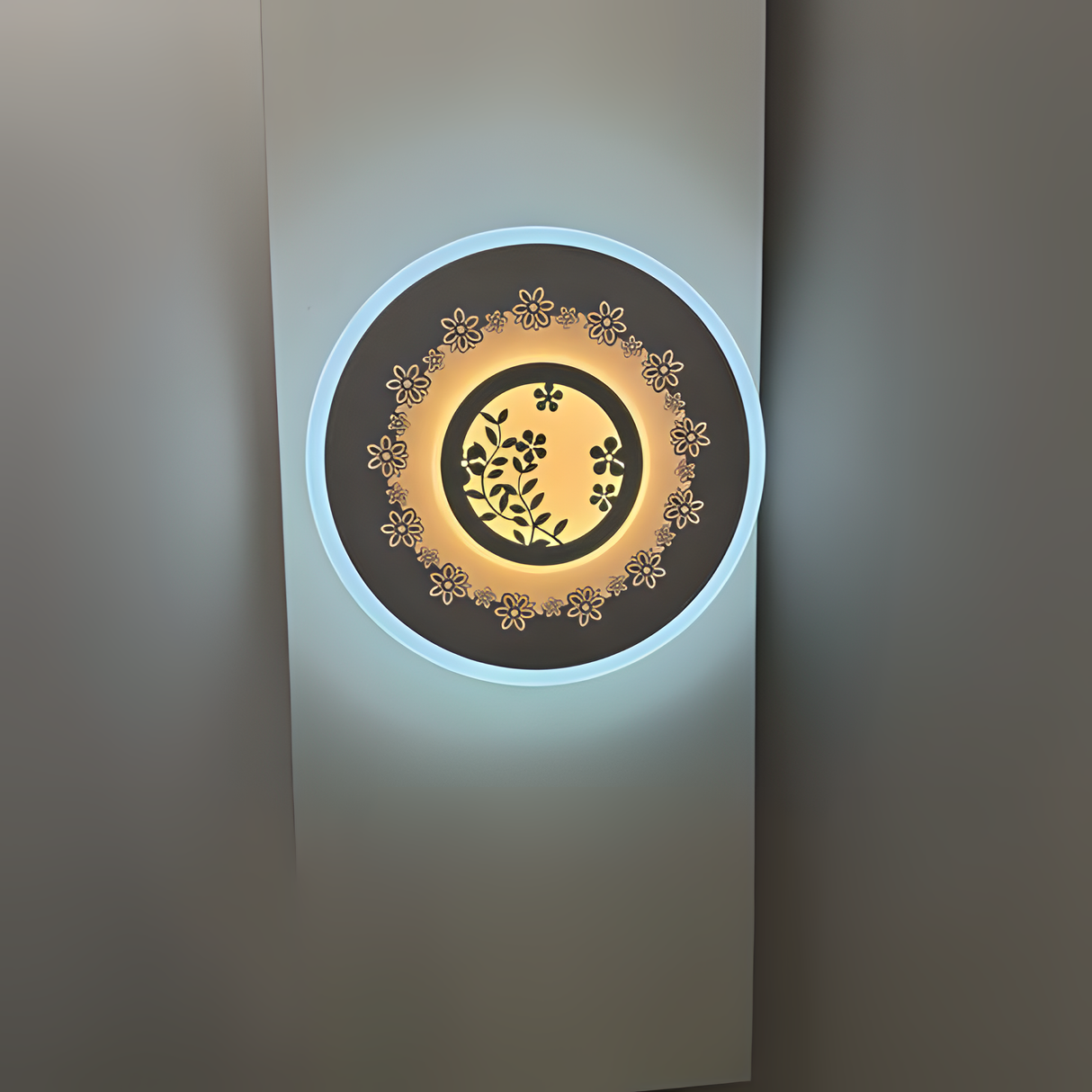 White round wall lamp featuring a small flower motif, mounted on a white wall.