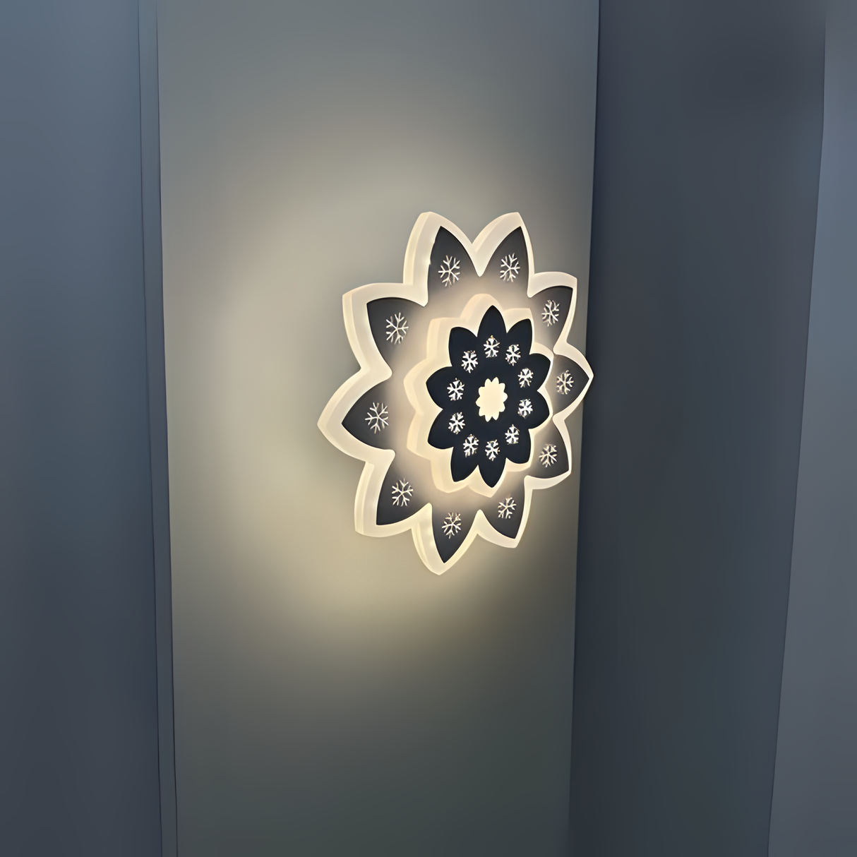 Modern Flower LED Wall Light in a sleek flower shape, crafted from metal and acrylic, fixed on a white wall, emitting soft, warm white light.