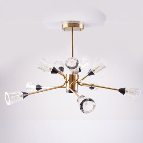 Modern chandelier with gold finish and multiple angled arms holding clear fluted glass shades.