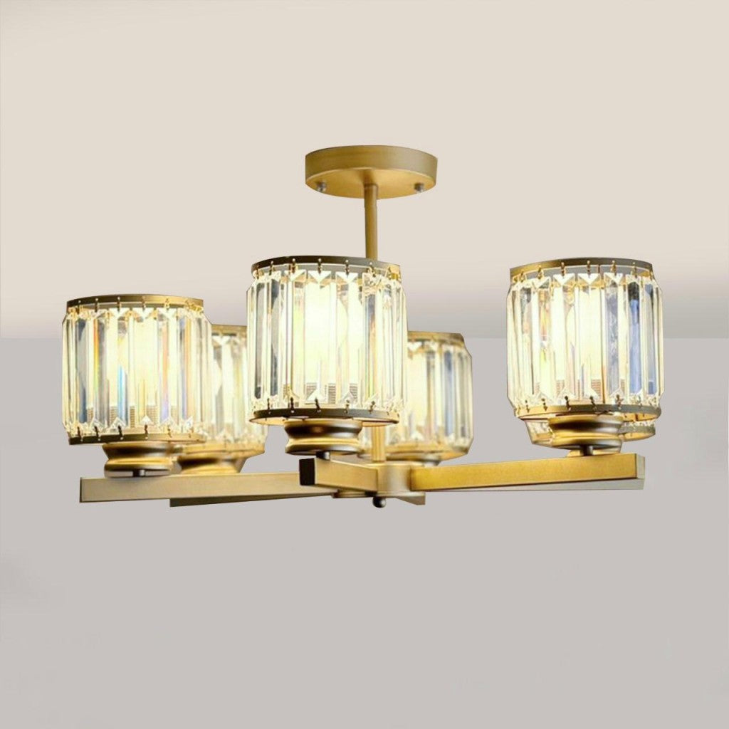  A contemporary ceiling light fixture featuring six cylindrical lamps with clear ribbed glass shades mounted on a gold metal frame against a plain white background.
