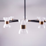 a close up of a sleek black linear chandelier with multiple arms, each holding a small white conical glass shade, mounted on a square ceiling base in a minimalistic setting.