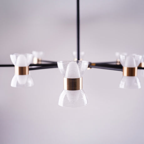 a close up of a sleek black linear chandelier with multiple arms, each holding a small white conical glass shade, mounted on a square ceiling base in a minimalistic setting.