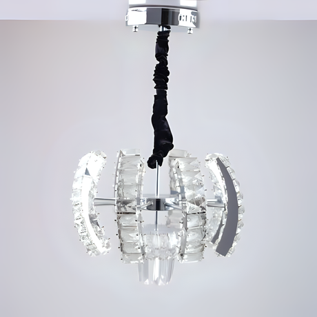  A crystal pendant chandelier with clear textured glass curved panels arranged in a globe formation, unlit, suspended from a black twisted cord and chrome ceiling plate.
