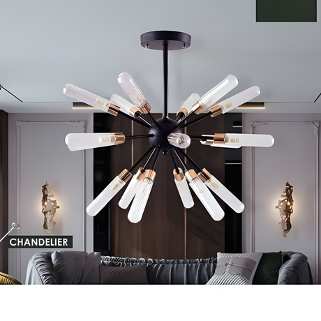 A black chandelier featuring long, exposed tube bulbs arranged in a striking starburst pattern, complementing a modern living room with a wall-mounted design, stylish sofa, curated wall decor, and ambient ceiling lighting.