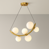 Modern pendant light with gold frame and white spherical bulbs on a neutral background
