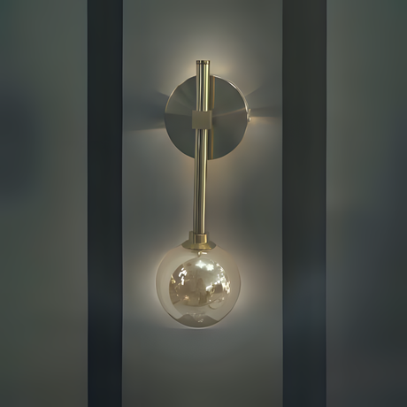 A wall light gold fixture with a beige glass globe equipped with a led lamp  hanging from a slim vertical rod, fixed on a dark wall.