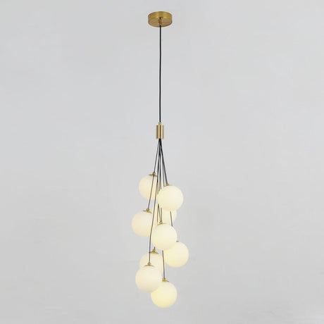 A cluster of frosted white glass globes hanging from a gold fixture, forming a cascading pendant light design.