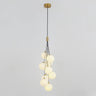  A cluster of frosted white glass globes hanging from a gold fixture, forming a cascading pendant light design.