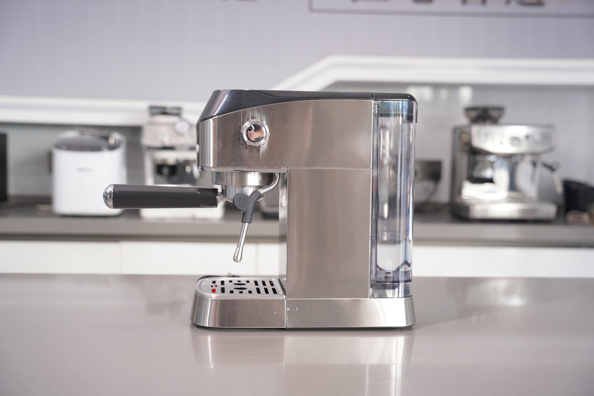 Stainless steel espresso machine on a kitchen counter with blurred background