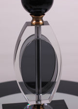  base is crafted from a combination of gold metal and transparent black glass with a geometric design.