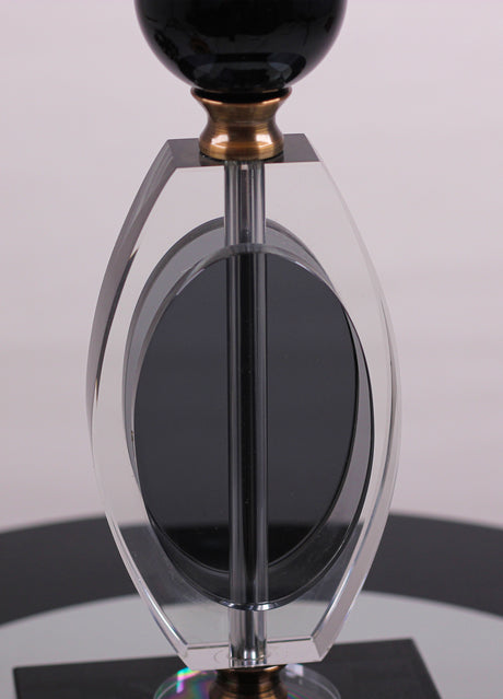  base is crafted from a combination of gold metal and transparent black glass with a geometric design.