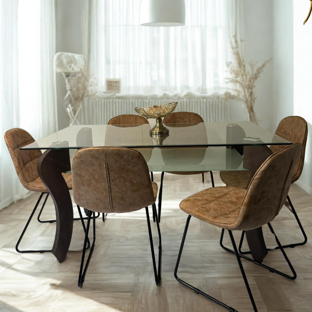 A sunlit dining room featuring a glass dining table with curved brown legs and six brown chairs on a light herringbone floor.