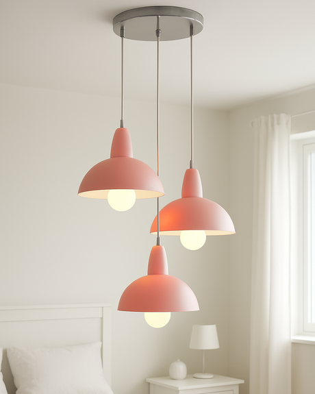 Three pink pendant lights hanging in a room with a neutral color scheme.