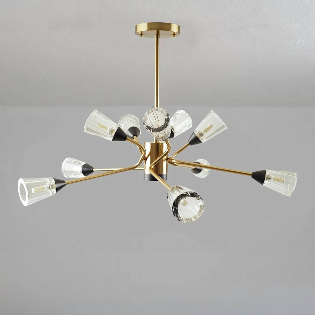 Modern chandelier with gold finish and multiple angled arms holding clear fluted glass shades.