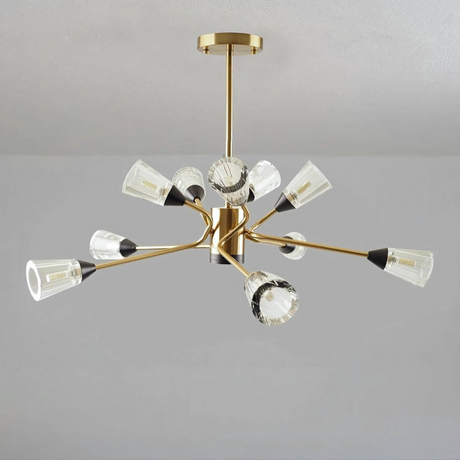 Modern chandelier with gold finish and multiple angled arms holding clear fluted glass shades.
