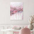 Dining room with pink chairs, a white table, and a floral painting on the wall.