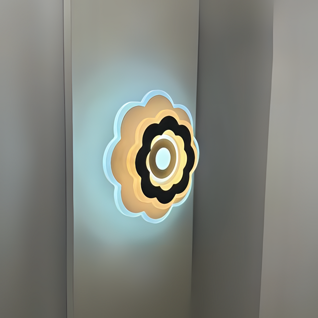 Modern Flower LED Wall Light in a sleek flower shape, crafted from metal and acrylic, fixed on a white wall, emitting soft, warm white light.
