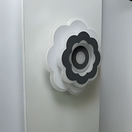 Modern Flower LED Wall Light in a sleek flower shape, crafted from metal and acrylic, fixed on a white wall, emitting soft, warm white light.