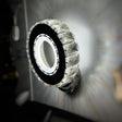 round wall sconce with a outer ring and embedded crystals, glowing from the center.