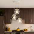 Modern kitchen with pendant lights hanging above a stove.