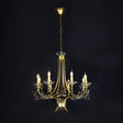 A classic gold chandelier with candle-style lights and intricate metalwork.
