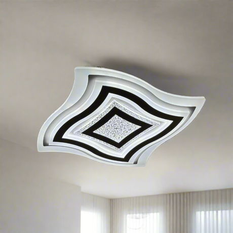 Modern all-white LED ceiling light with layered, wavy square design and textured central diffuser, mounted flush to the ceiling.