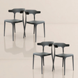  Four dark gray sculpted chairs with artistic backrests, arranged in a square formation on a glossy floor.
